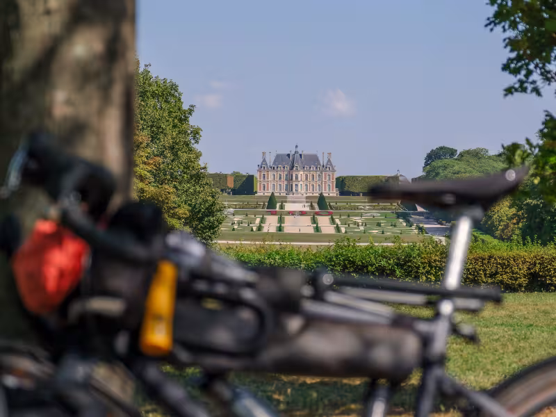 Vélos de voyage sur la coulée verte du sud parisien avec vue sur le château et les jardins du domaine de Sceaux, étape de la Véloscénie en Île-de-France.